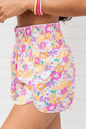 Floral print shorts with scalloped hem and elastic waist in blush pink.