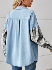 Light wash denim shirt with leopard print sleeves and button-up front.