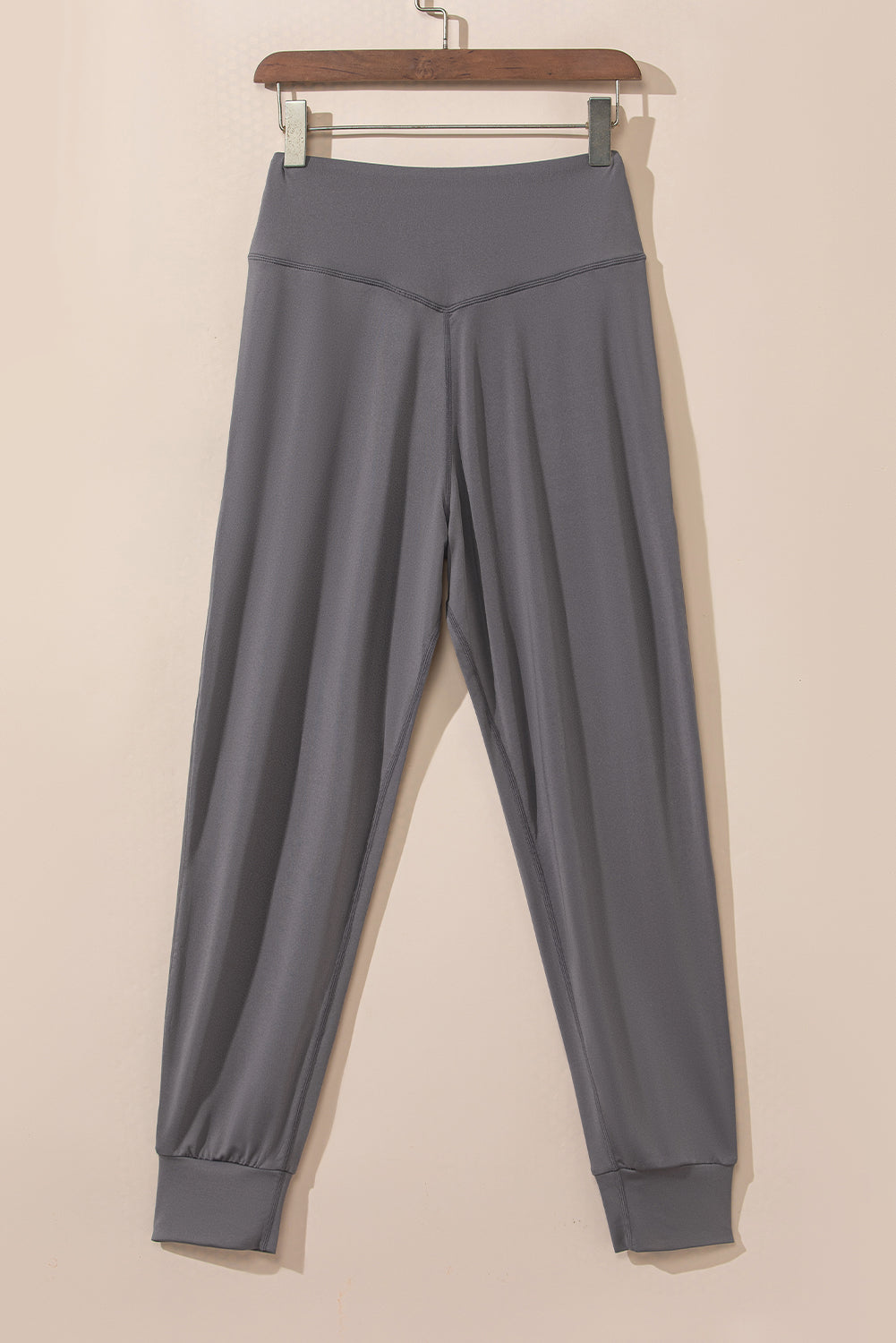 Dark gray joggers with a V-shaped waistband and cuffed ankles.