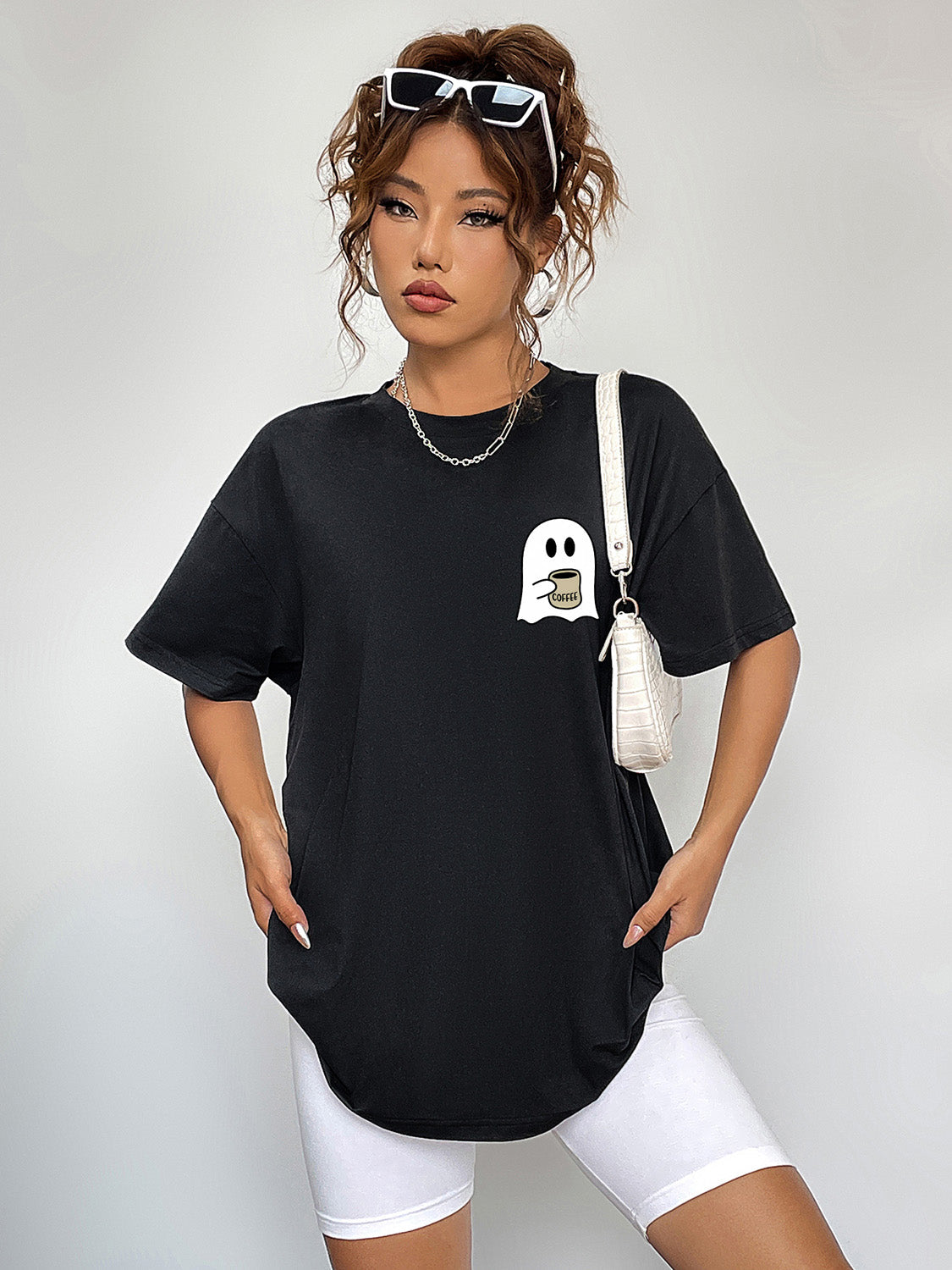 Black t-shirt with a white ghost graphic holding a coffee cup.