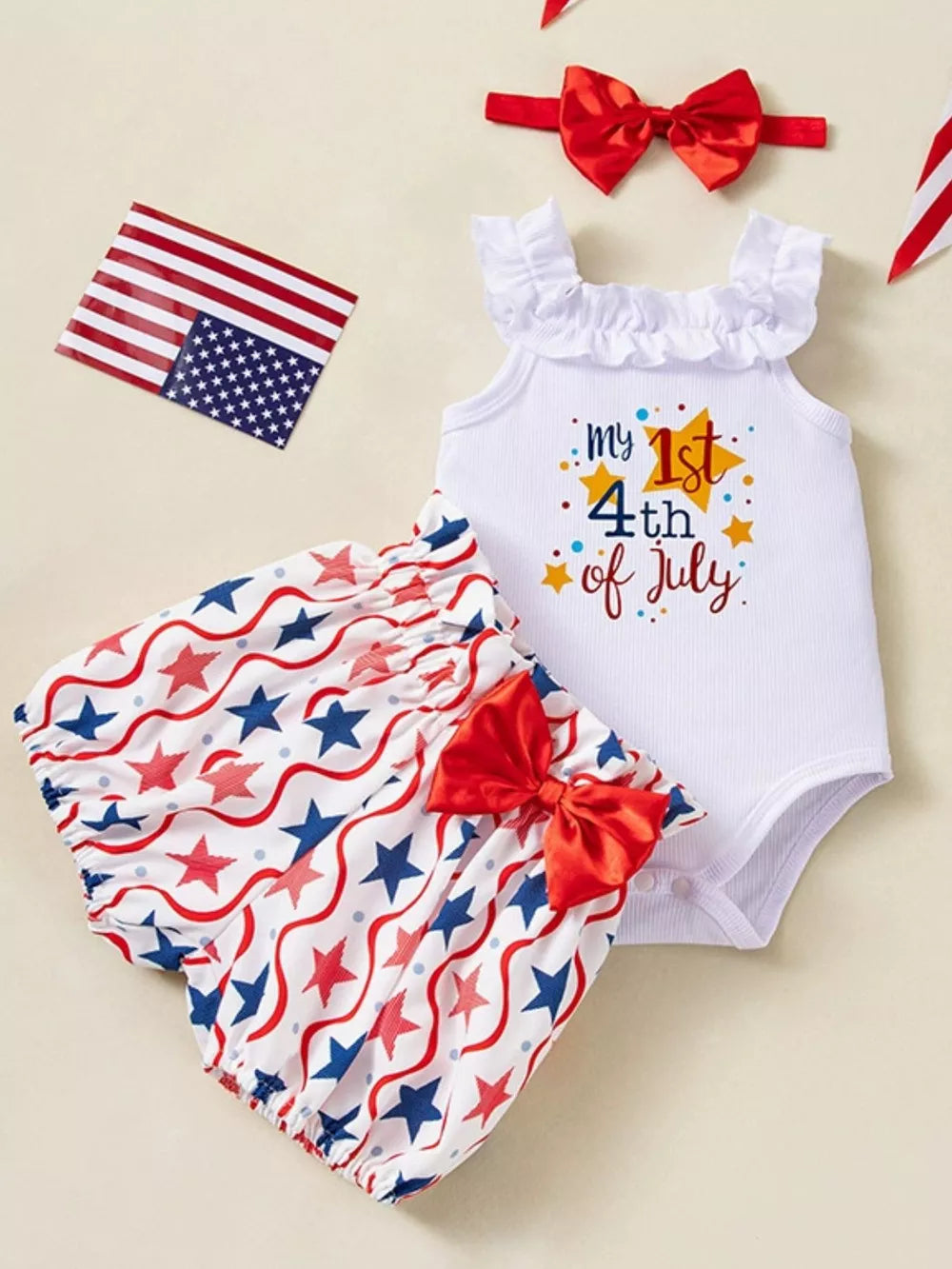 Baby patriotic three-piece set with ruffled white bodysuit and star-print bloomer shorts.
