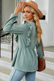 Light green textured peplum blouse with ruffle detail and long sleeves