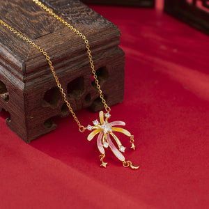 18k gold starburst pendant necklace with pink and yellow enamel and cubic zirconia accents.