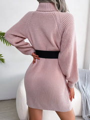 Dusty pink ribbed knit turtleneck sweater dress with balloon sleeves and a black belt.