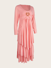 Pink tiered midi dress with long sleeves, ruched bodice and heart detail.