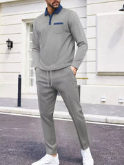 Men's gray two-piece lounge set with polo shirt and drawstring pants.