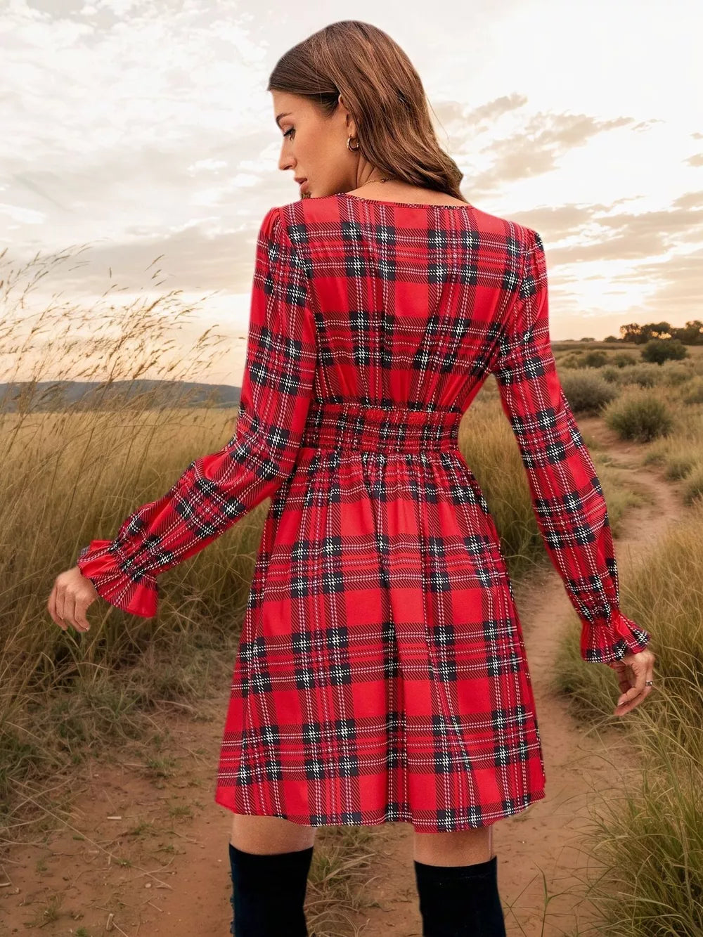 Red plaid mini dress with smocked waist and ruffled cuffs.