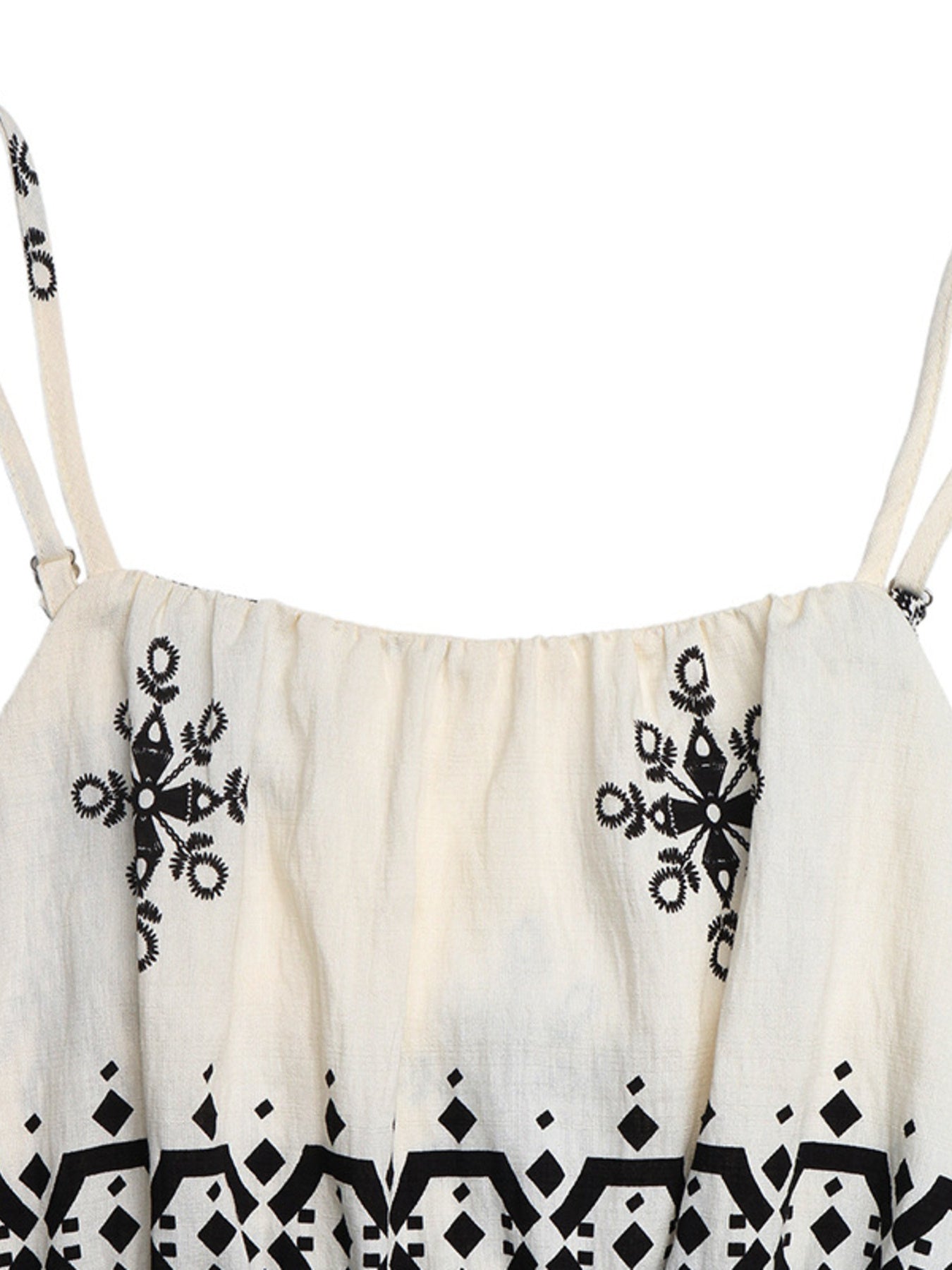 Beige romper with spaghetti straps, elastic neckline, and black folk-inspired embroidery and geometric print.