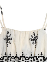 Beige romper with spaghetti straps, elastic neckline, and black folk-inspired embroidery and geometric print.