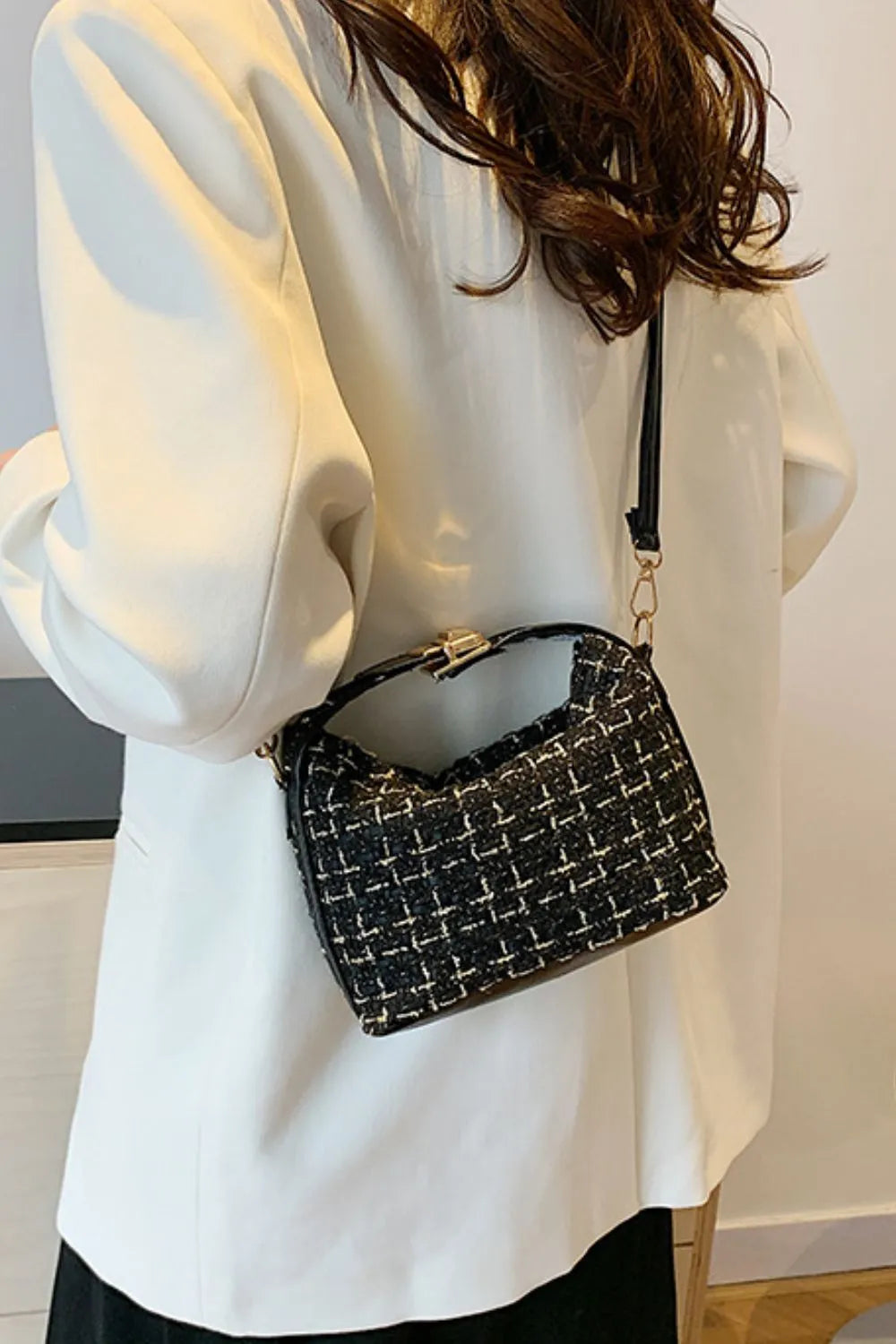 Black tweed box bag with gold hardware and detachable strap styled with a white blazer