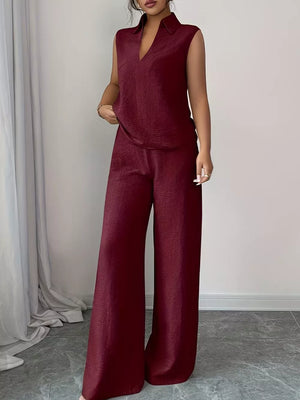 Burgundy sleeveless collared top and wide-leg pants set with textured fabric.