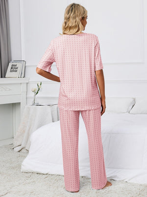 Dusty pink geometric print V-neck lounge set with short sleeves and wide-leg pants.
