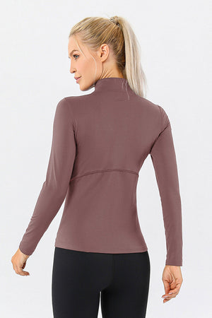 Athleisure zip-neck top in Dusty Pink with seam detail and long sleeves.