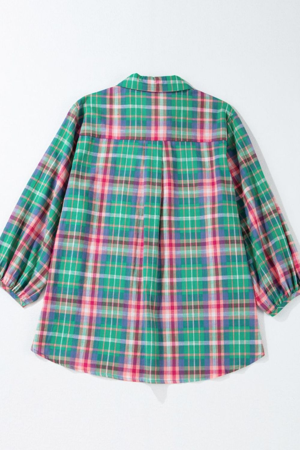 Voluminous plaid blouse with gathered sleeves and a collared neckline in green and pink plaid.