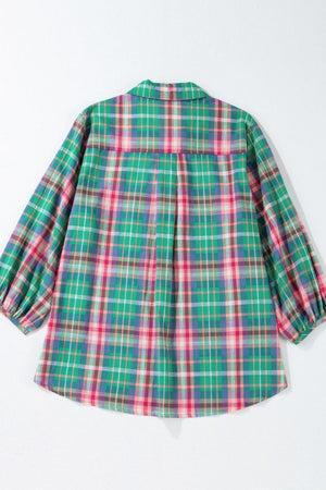 Voluminous plaid blouse with gathered sleeves and a collared neckline in green and pink plaid.