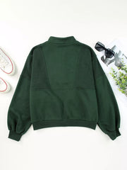 Dark green half zip stand collar sweatshirt with paneled detail