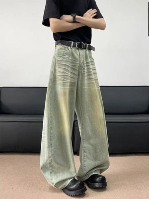 Men's oversized light blue cotton jeans with creasing detail and a relaxed fit.