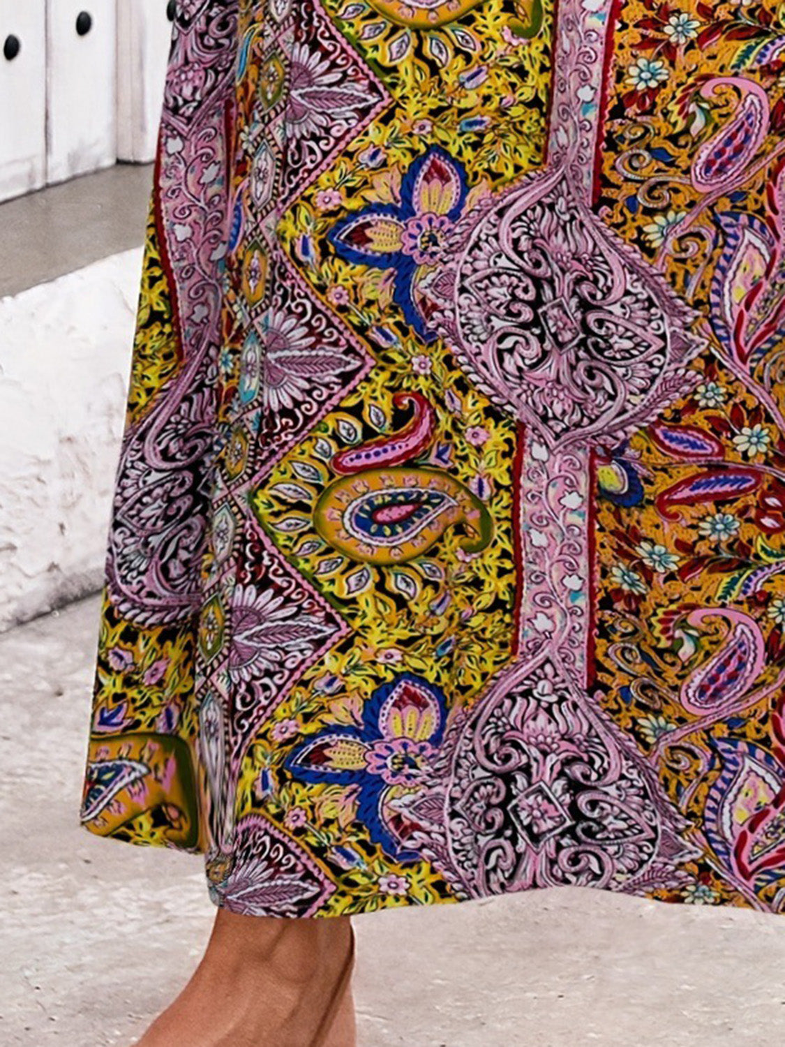Paisley print maxi skirt in yellow-green with a side slit and bohemian pattern.