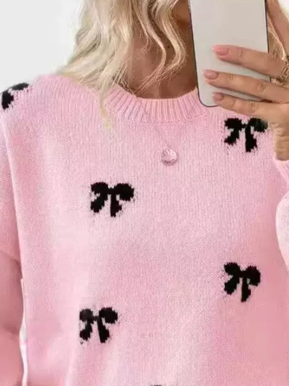 pullover sweater featuring bow-print in Apricot with 100% polyester Care instructions: Machine wash cold texture