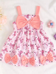 Pink baby dress with bow print and large bow detail, cotton fabric.