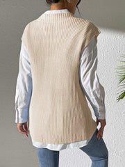 Beige ribbed knit sleeveless vest with mock neck over white shirt