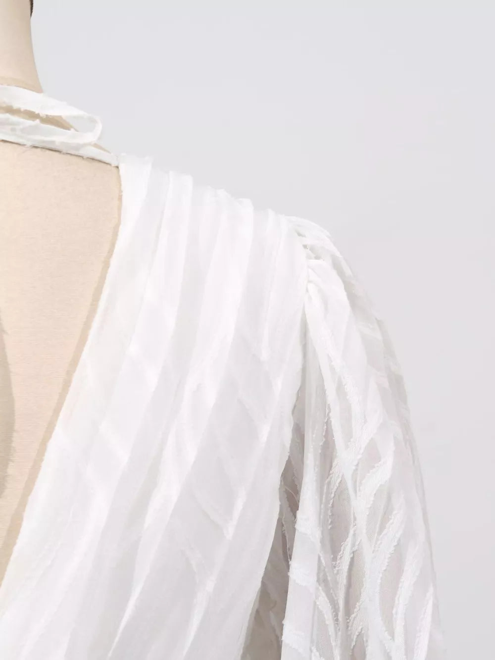 White maxi dress with textured fabric and balloon sleeves
