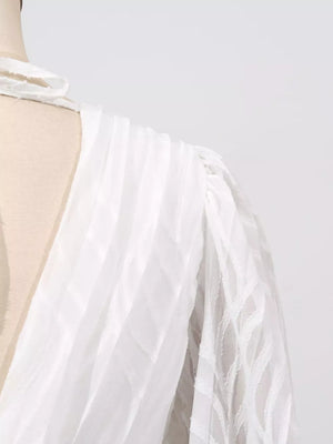 White maxi dress with textured fabric and balloon sleeves
