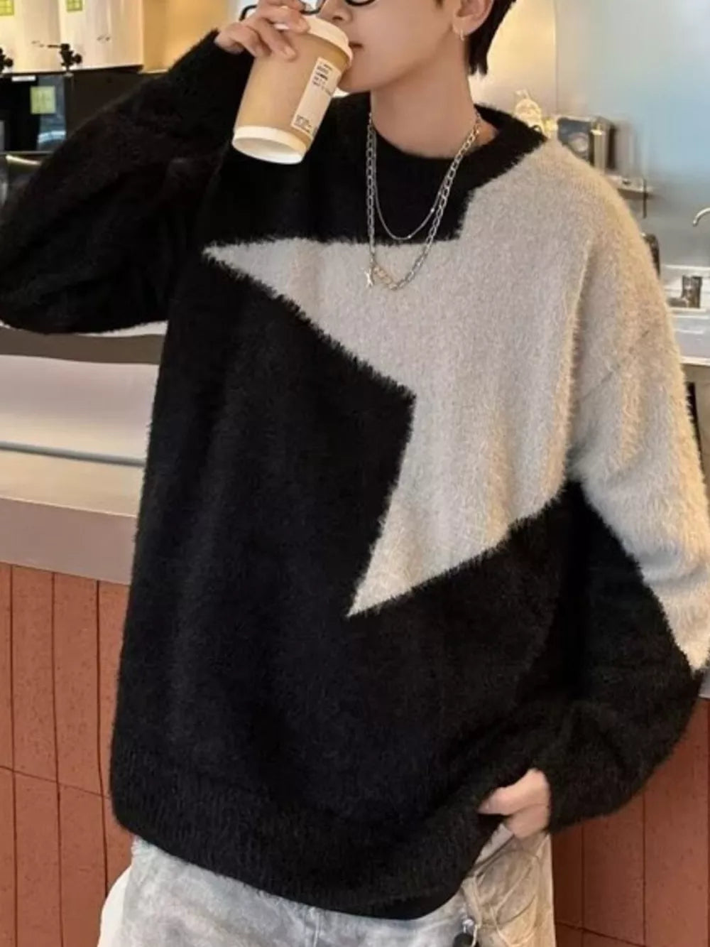 Men's black and cream fuzzy knit geometric crew neck sweater.
