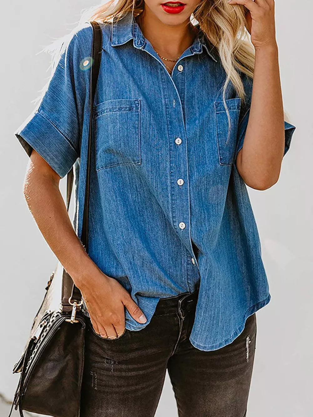 Denim button-front shirt in dark blue with short sleeves and two chest pockets.