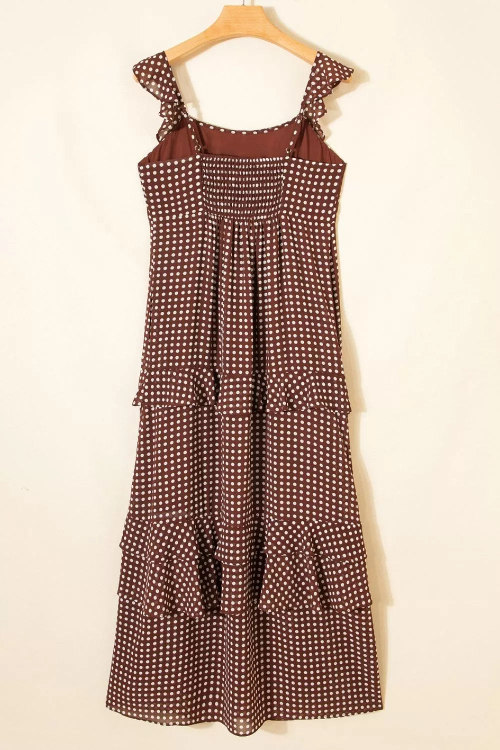 Brown polka dot maxi dress with ruffled straps and tiered skirt.