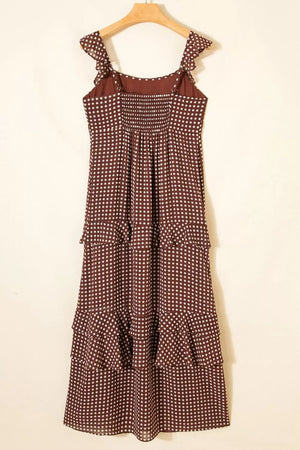 Brown polka dot maxi dress with ruffled straps and tiered skirt.