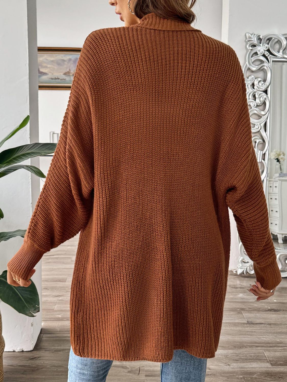 Brown ribbed knit cocoon cardigan with dropped shoulders and cuffed sleeves.