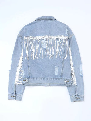 Light wash denim jacket with sequined fringe and distressed details.