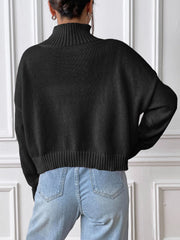 Black cropped ribbed turtleneck sweater with a relaxed fit and cuffed hem.