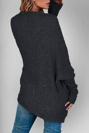 Black popcorn knit open cardigan with textured fabric and long sleeves.