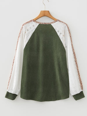 Dark green striped waffle knit top with white lace sleeves and animal print trim.