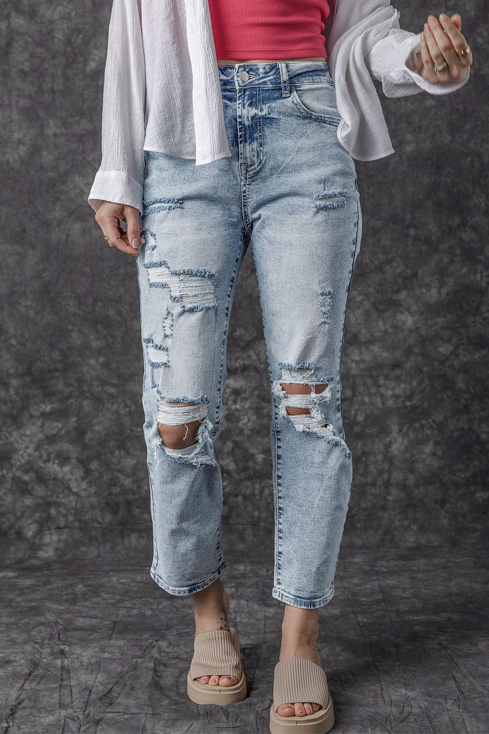 Distressed wash light denim slim leg jeans with ripped details