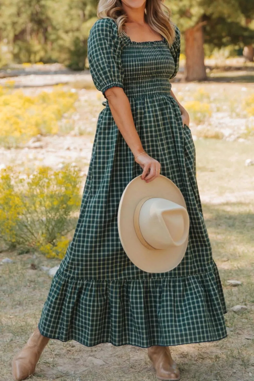 Plaid maxi dress with square neck, smocked bodice, puff sleeves, and ruffled hem.