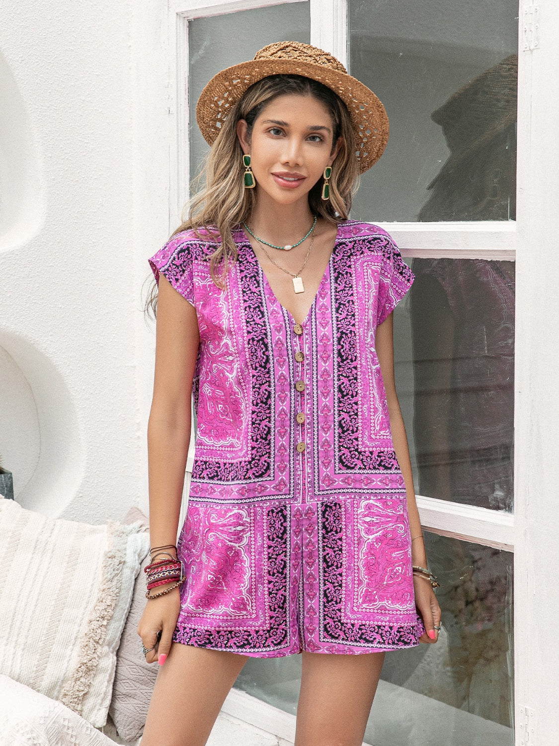 Bohemian print cap-sleeve playsuit in red-violet with button front and V-neck.