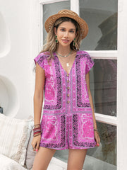 Bohemian print cap-sleeve playsuit in red-violet with button front and V-neck.