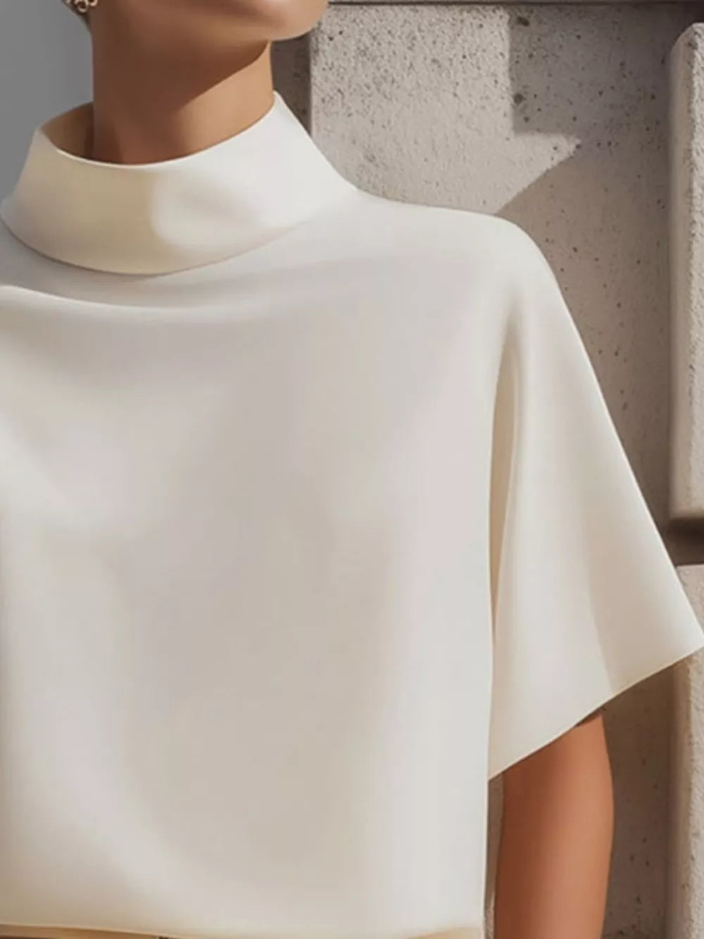White mock neck t-shirt with relaxed short sleeves, made of polyester.