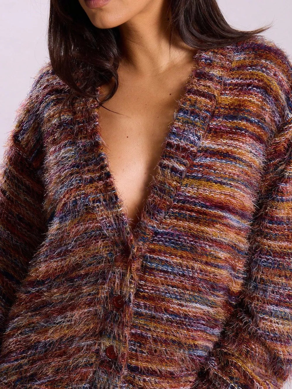 Cozy textured knit cardigan with buttons in a multicolor stripe pattern.