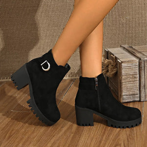 Black suede round toe ankle boots with block heel and decorative buckle detail.