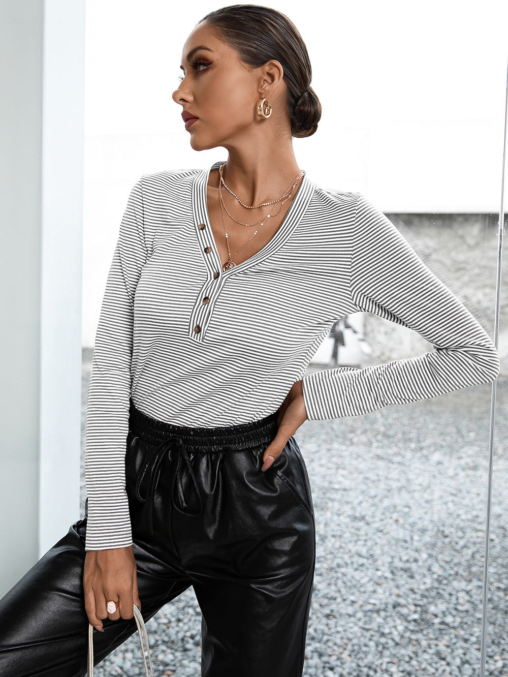Ribbed Henley stripe top with button detail and long sleeves.