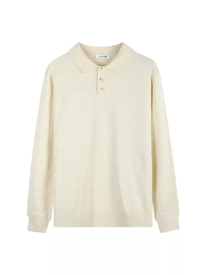 Apricot knit polo shirt with button accents and textured pattern.
