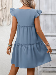 Gray blue ruffled cap sleeve mini dress with tiered skirt and textured fabric.