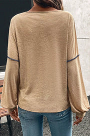 Contrast stitch v-neck t-shirt in tan with long balloon sleeves and blue stitching detail.