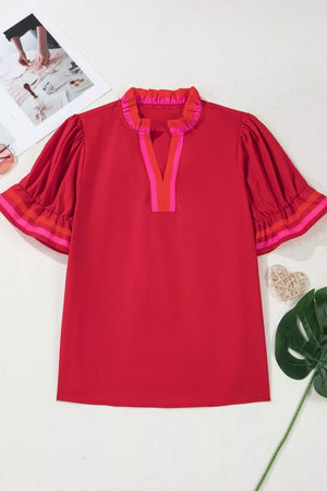 Red maternity blouse with ruffled neckline and striped sleeve accents