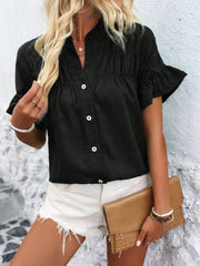 Black button-up blouse with gathered yoke and ruffle sleeves.