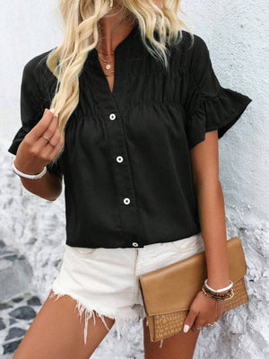 Black button-up blouse with gathered yoke and ruffle sleeves.